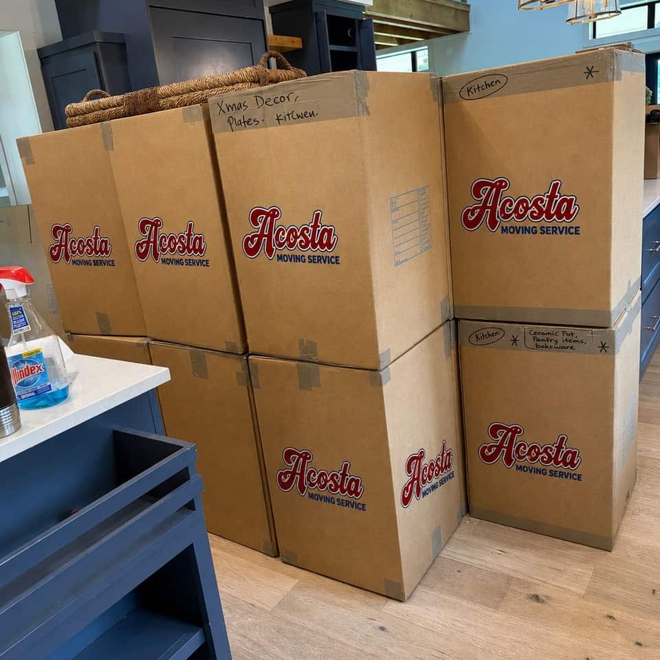 Packed Acosta Moving Service boxes stacked in a kitchen before the move